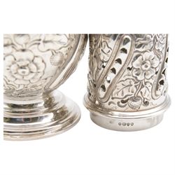 Victorian silver sugar caster, of typical waisted form with engraved and embossed floral and berry decoration, the removable pierced cover with urn finial, upon a circular stepped foot, hallmarked Charles Edwards, London 1884, H20.5cm