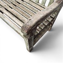 Teak garden bench with slatted back and seat raised on square supports