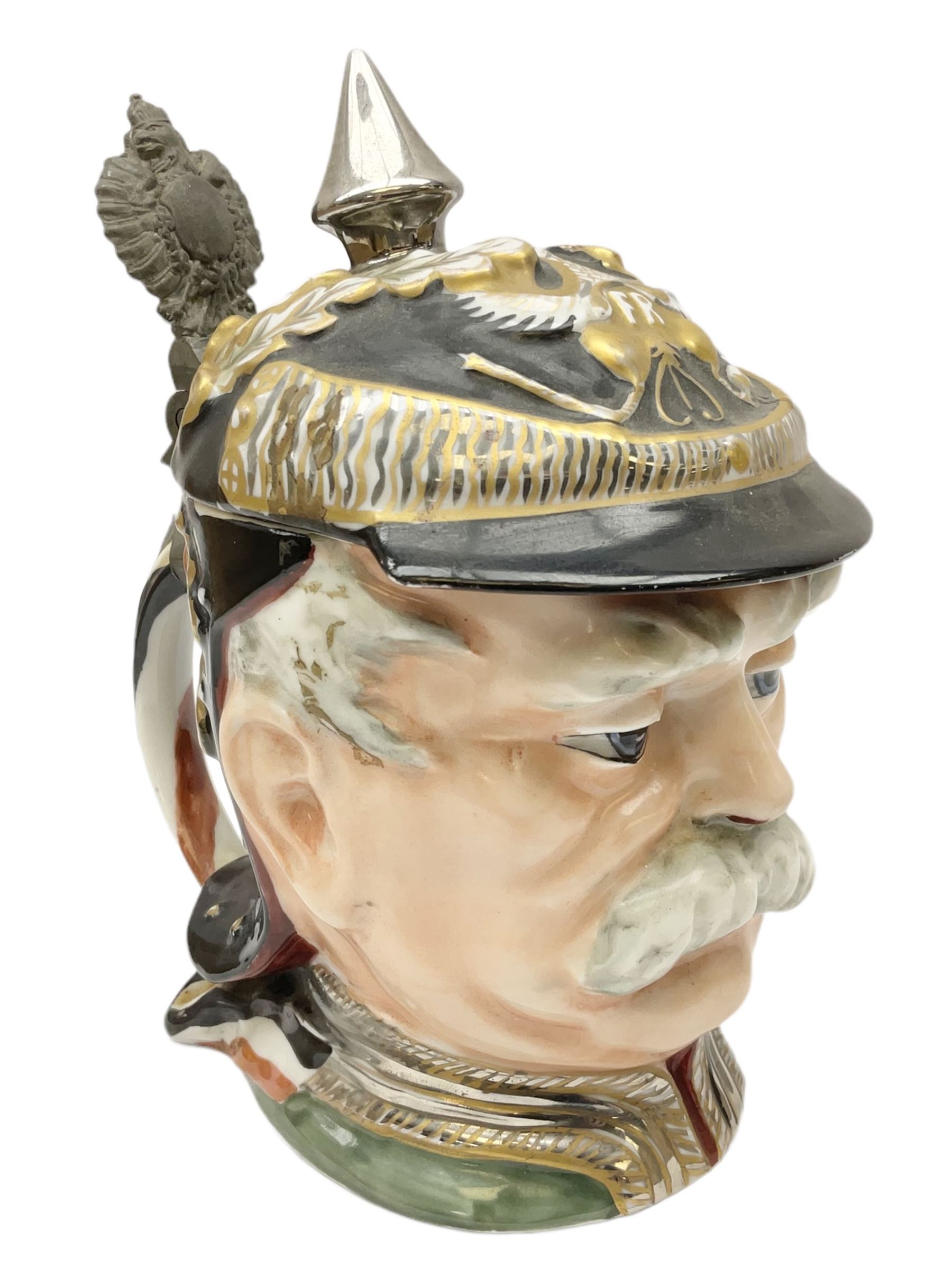 Otto Von Bismarck figural 0.5l stein, his black pickelhaube helmet with chrome spike serving as the lid, in green uniform and gilt detail throughout, pewter thumb hinge, with blue hash Musterschutz type mark, H18cm