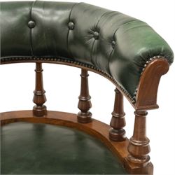 Late Victorian mahogany framed Captains tub desk chair, the green leather upholstered cresting rail over turned spindle supports over a sprung seat, raised on front turned supports terminating to ceramic castors
