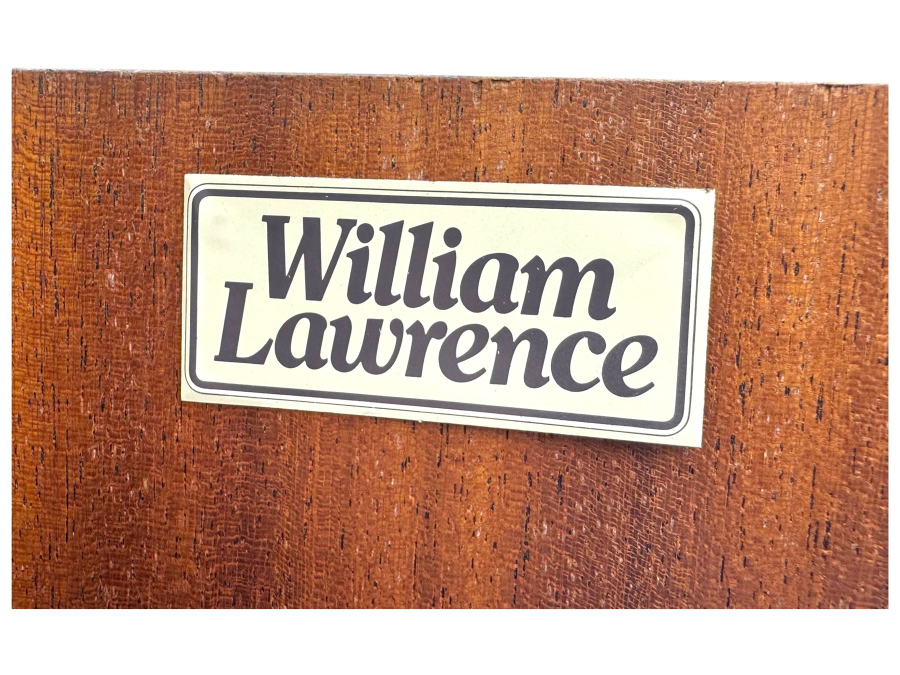 William Lawrence - mid-20th century teak double wardrobe, upper storage section over twin doors featuring recessed handles and contrasting horizontal panel, enclosing a hanging rail compartment, on plinth base with concealed castors