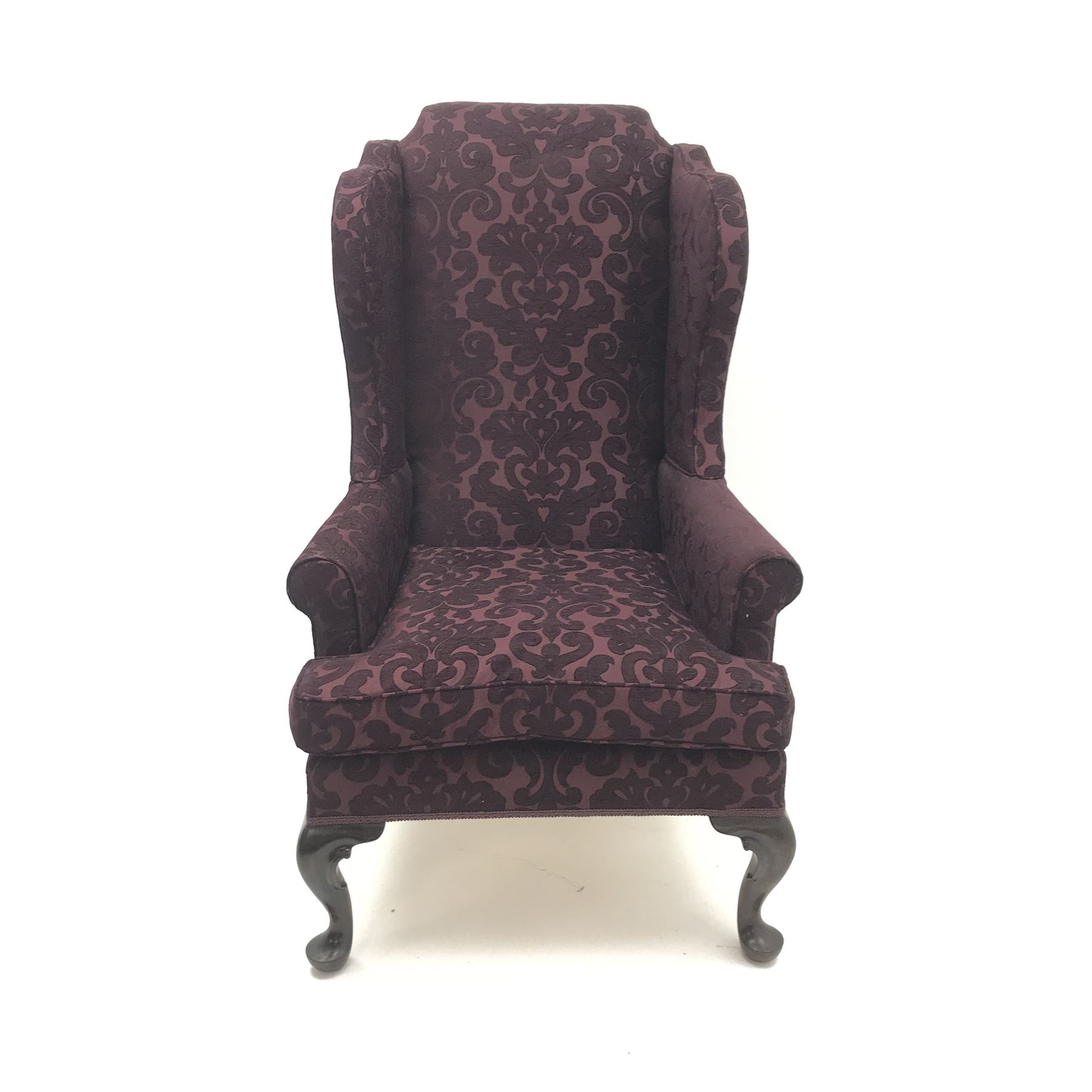 Traditional Queen Anne style high wingback armchair upholstered in purple fabric with raised scrolling pattern, on cabriole feet