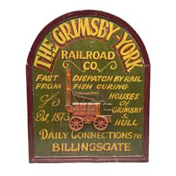 `The Grimsby-York Railroad Co.` painted wooden railway advertising sign 20th century, of planked construction with arched top and moulded border, decorated with an applied wood and metal image of an early steam locomotive in relief, the surrounding wording reading `The Grimsby-York Railroad Co., Fast Dispatch by Rail from Fish Curing Houses of Grimsby & Hull, Est. 1873, Daily Connections to Billingsgate`, 89 x 71cm
