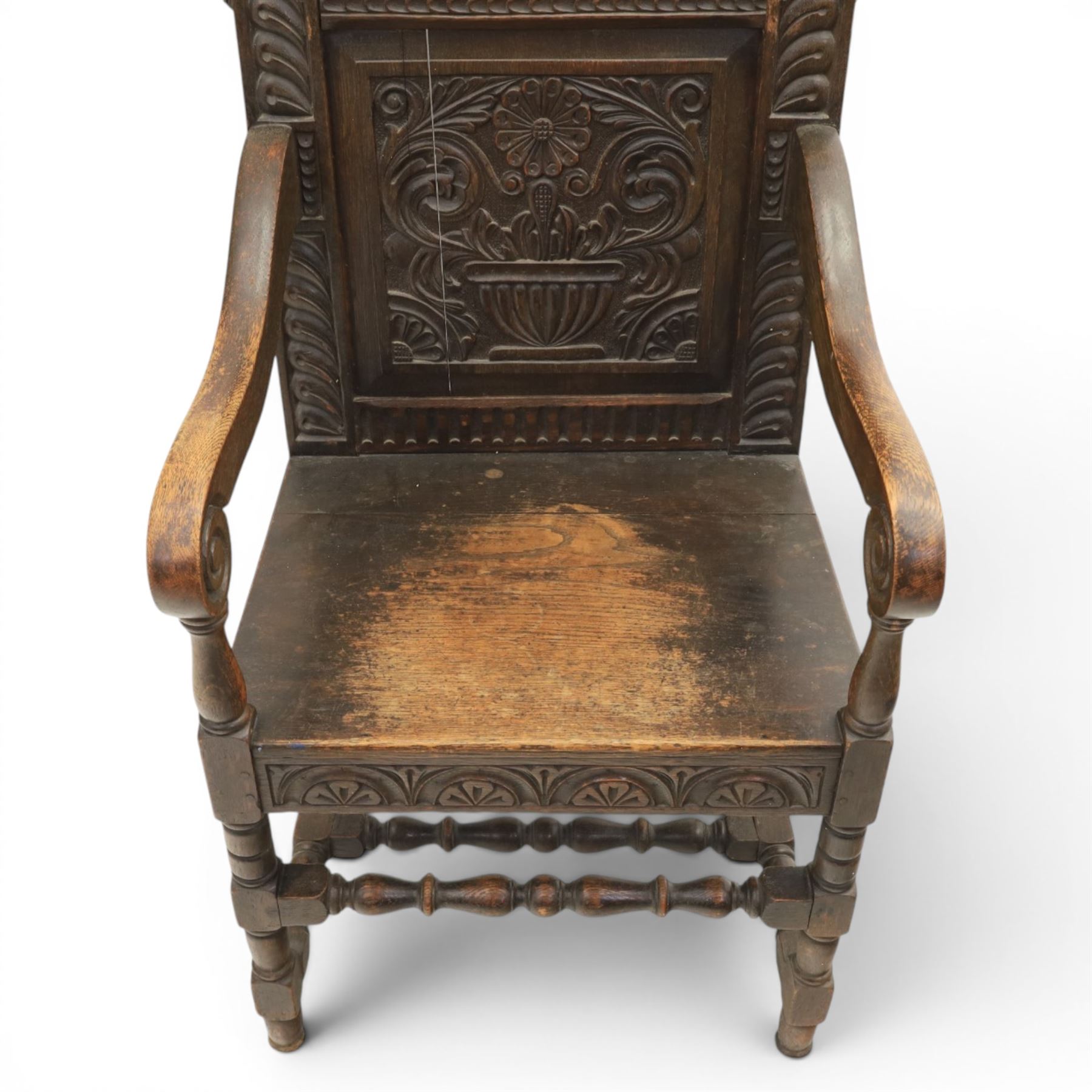 17th century style carved oak Wainscott chair, intricately carved back, united by a turned stretcher