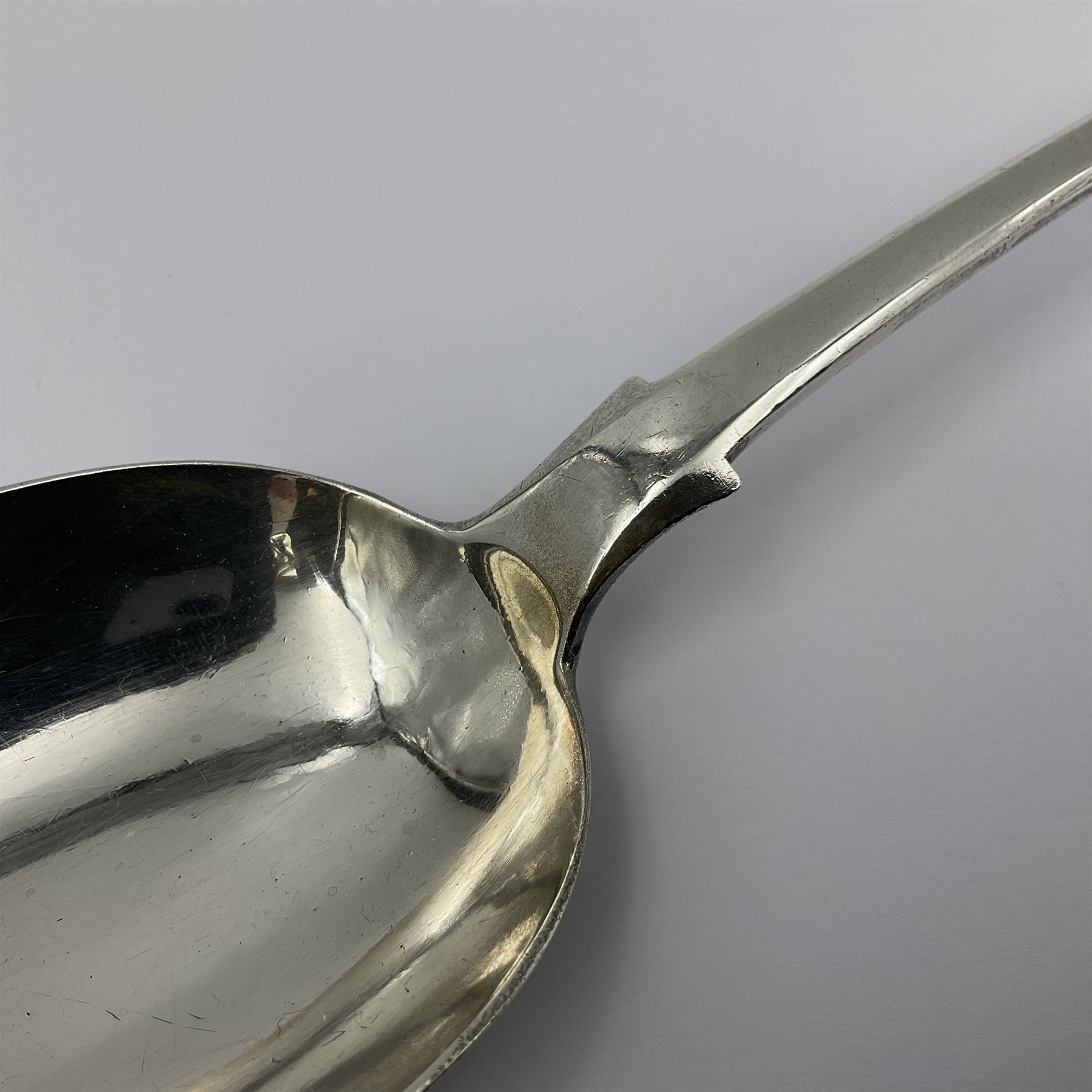 Victorian Newcastle silver Fiddle Shell pattern serving spoon, the terminal engraved with crest of a fist holding an arrow aloft, hallmarked Lister & Sons, Newcastle 1862, L31cm