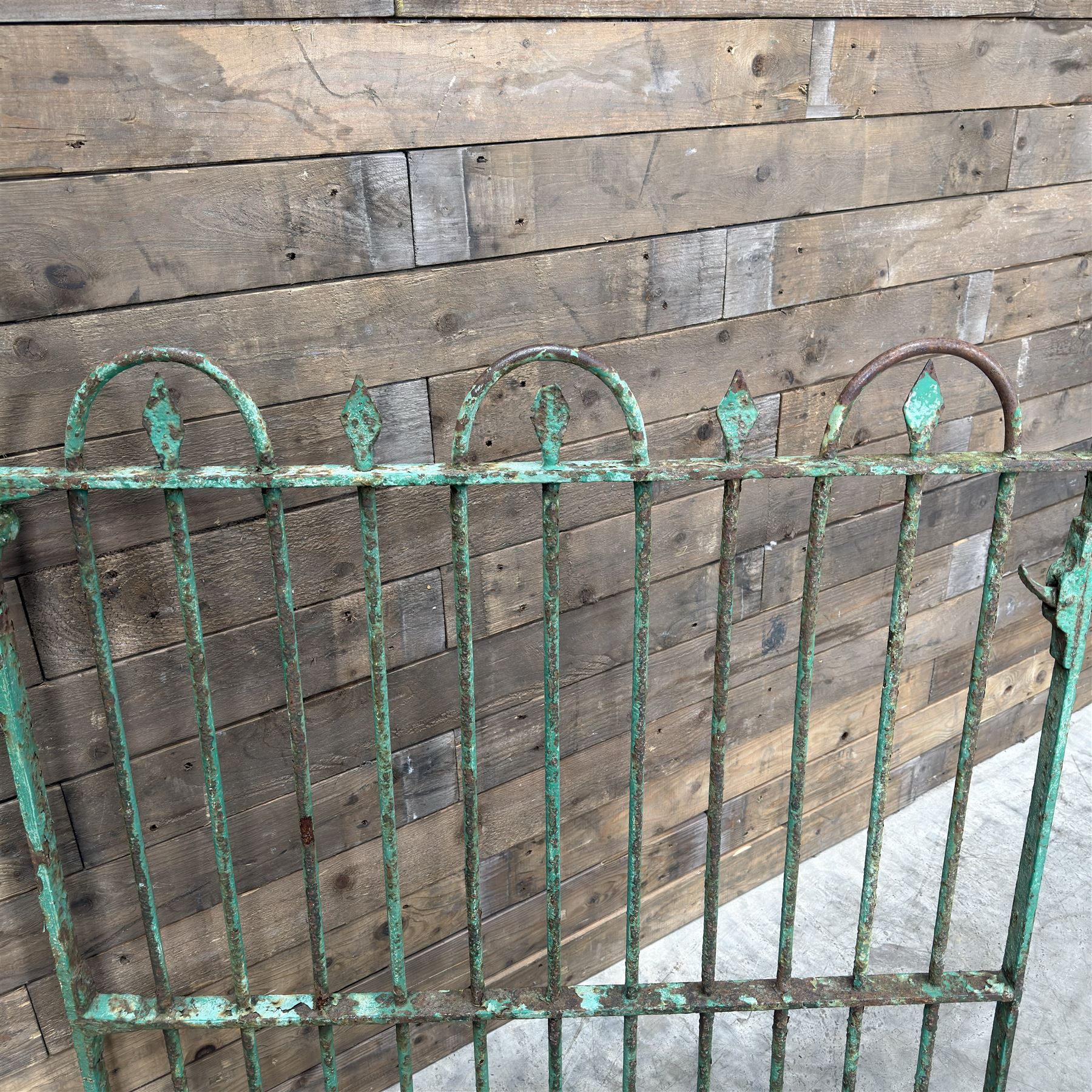 19th century French cast iron garden gate, finished in green rustic paint, bar form with hoop and spear top, with loop hinge brackets
