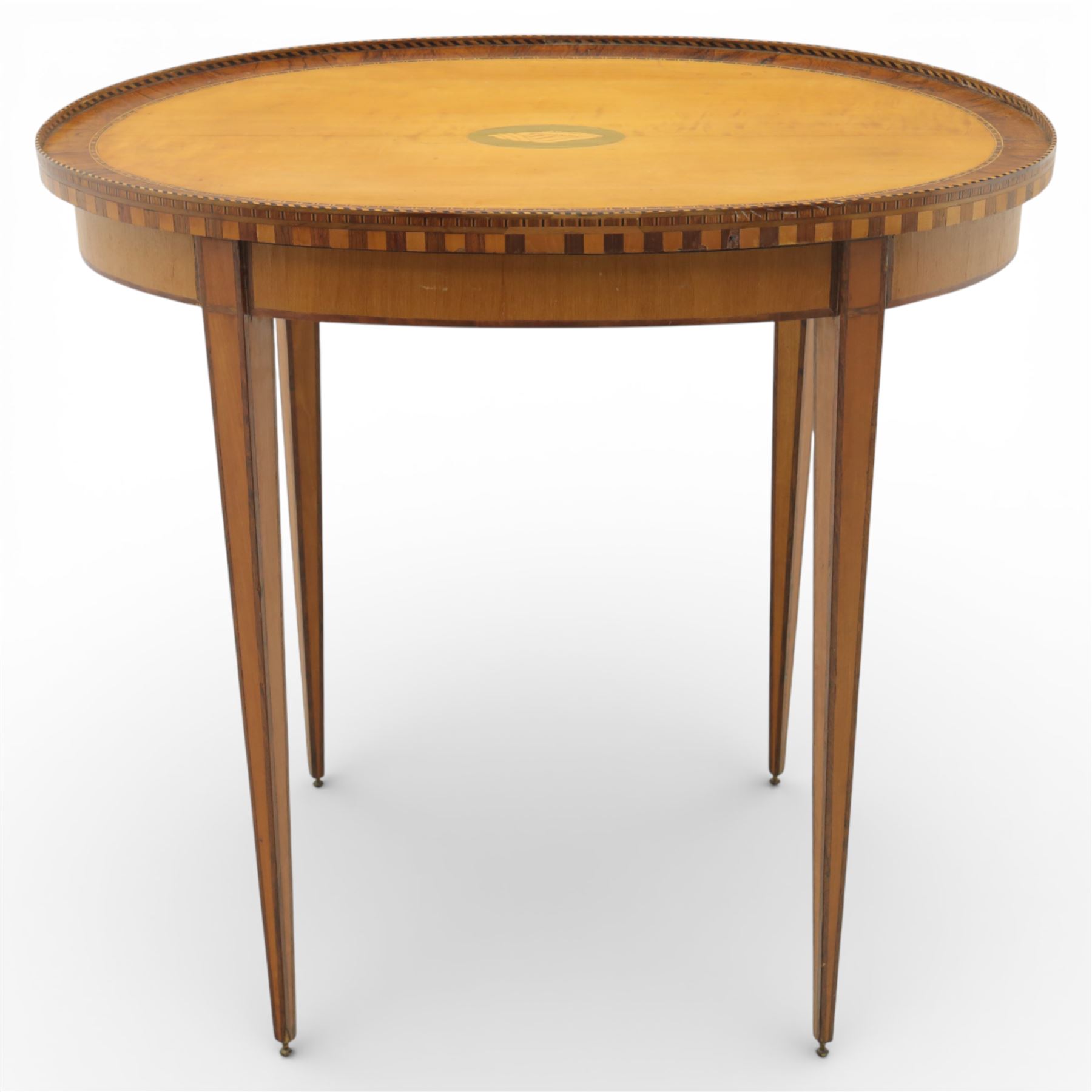 Early 19th century Sheraton revival satinwood oval table, shell motif to the centre bordered by walnut veneer, with inlaid banding, supported on square tapering legs terminating in brass feet