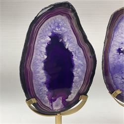 Pair of purple agate slices, polished with rough edges raised upon gilt metal stands