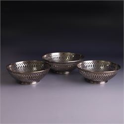 Three 1930s silver bon bon dishes, comprising pair and one larger example, each of circula...