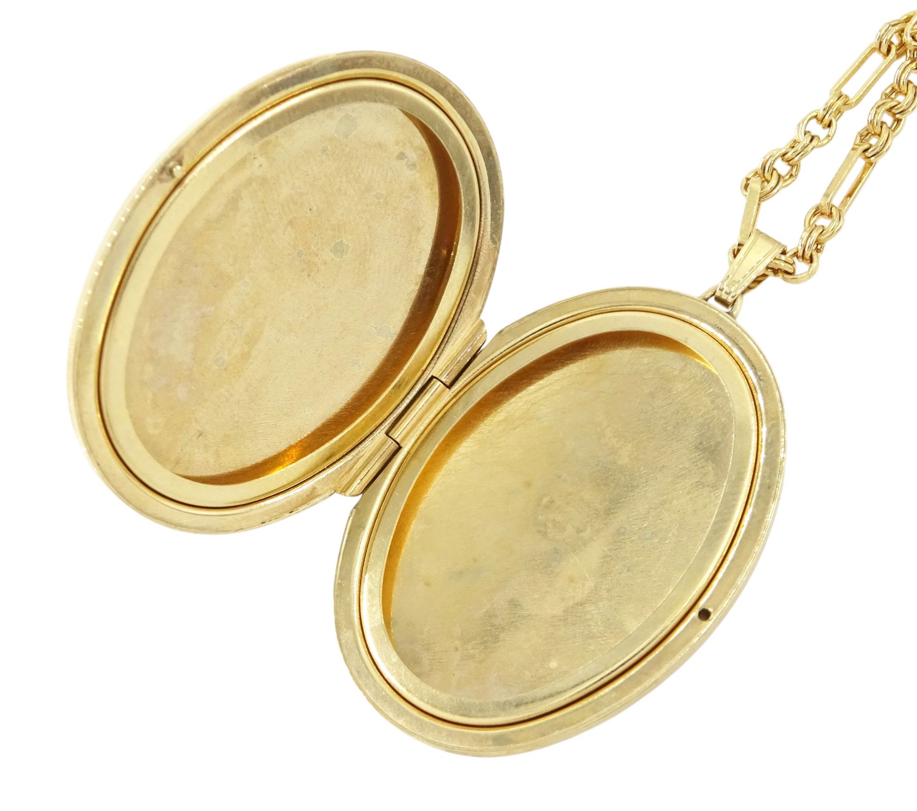 Gold oval locket with engraved decoration, on a gold fancy link chain, both 9ct, hallmarked 
