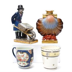 Russian, probably Gardner figure of a man pushing a wheelbarrow on gilt lined rectangular ...