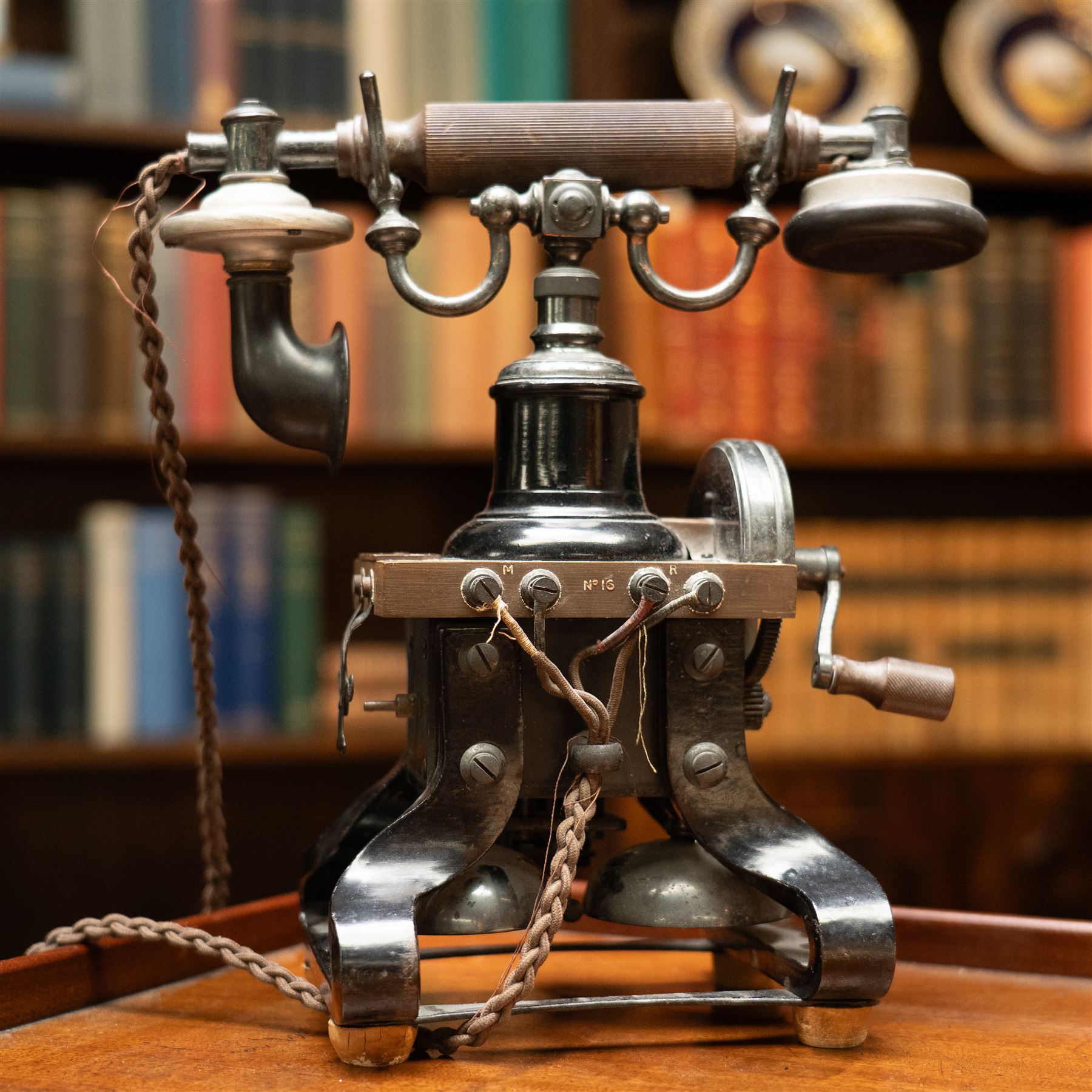 Early 20th century L M Ericsson & Co Skeletal table telephone, the earpiece impressed No.28, with black painted frame and possibly original wires, H29cm