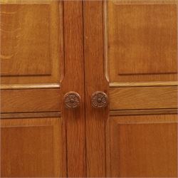Beaverman - oak double wardrobe, enclosed by twin multi-panelled doors, Yorkshire Rose carved handles, the interior fitted with shelf and hanging rail, with signature carved beaver, by Colin Almack of Sutton, near Thirsk