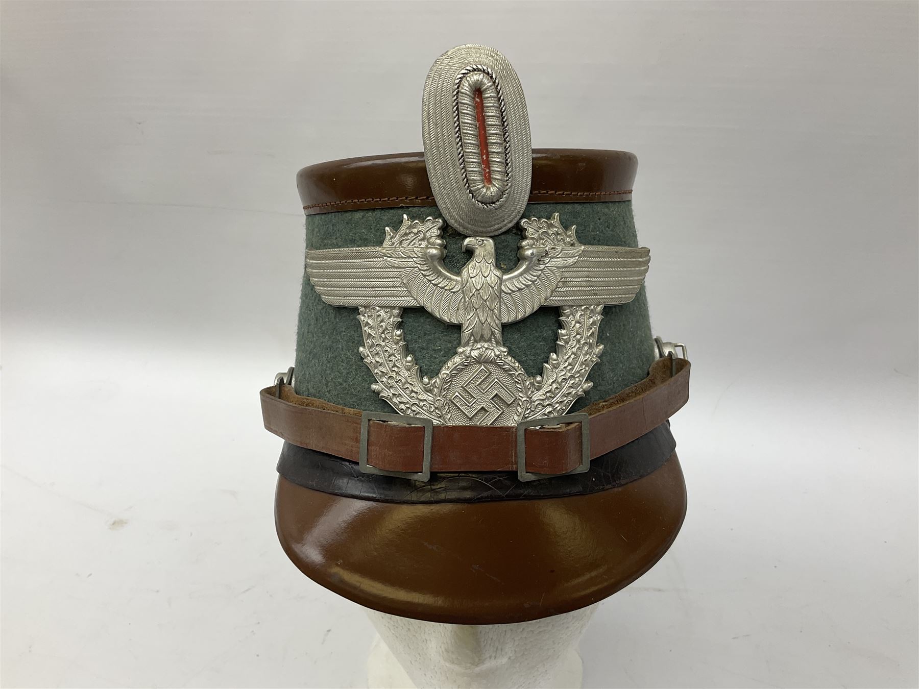 WW2 German rural police shako with helmet plate and liner; bears label 'Hans Romer Echt Fiber-Tschako Neu-Ulm (Donau)'