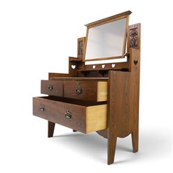 Shapland & Petter - oak mirrored dressing chest, tilted mirror flanked by tulip carved supports, shaped shelves with heart cut outs, above two short over one long drawers, with brass handles and stamped S & P on the locks, raised on shaped supports