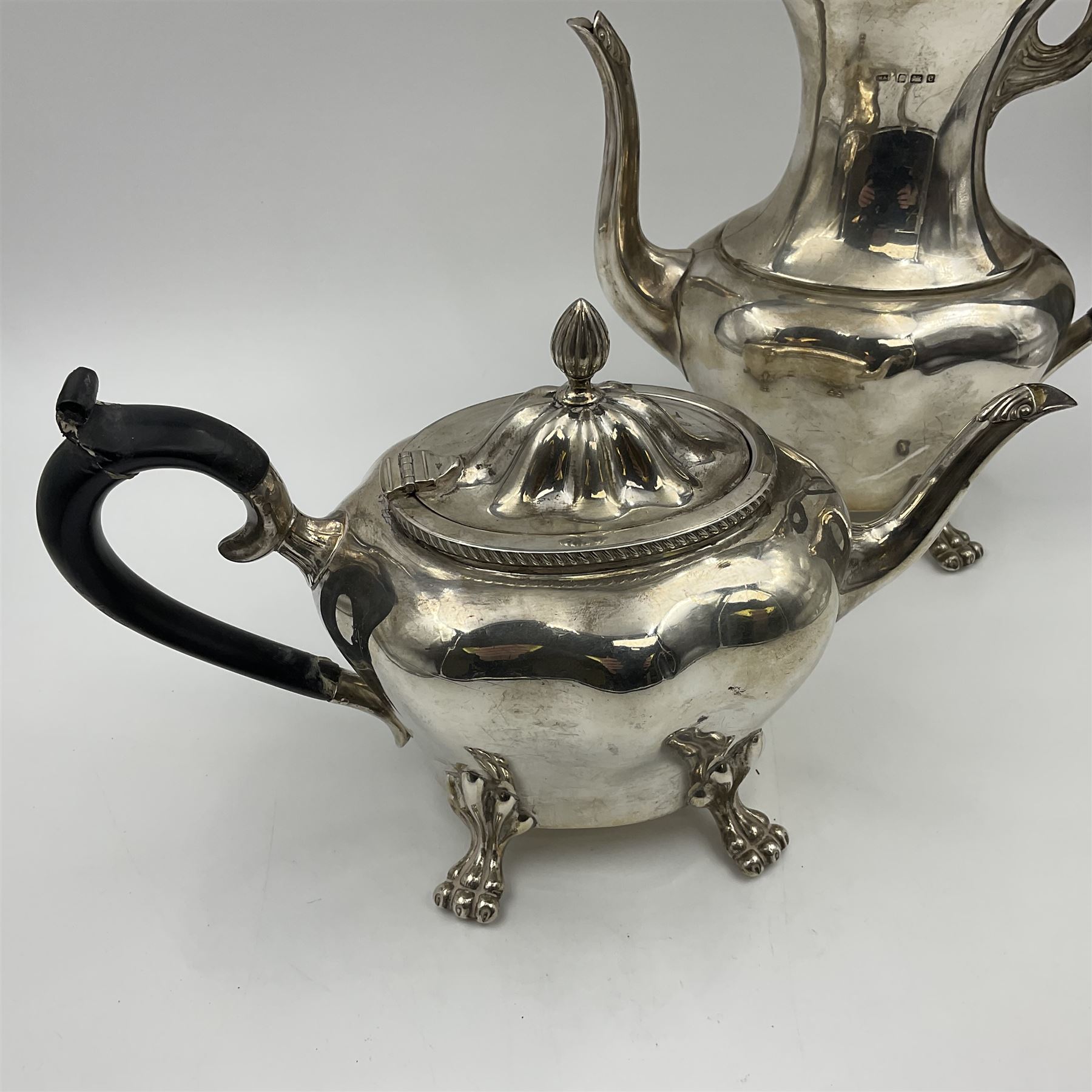 Five piece Edwardian silver tea service, comprising teapot and coffee pot, each with ebonised scroll handle, tea caddy with hinged cover, twin handled open sucrier, and milk jug, each of rounded bombe form, upon four paw feet, hallmarked William Adams Ltd, Birmingham 1904 and 1905, coffee pot H26cm
