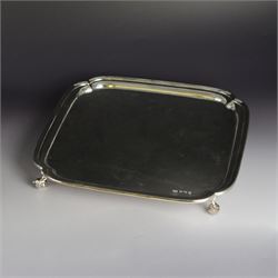 1930s silver salver, of square form with curved corners, upon four scroll feet, hallmarked...