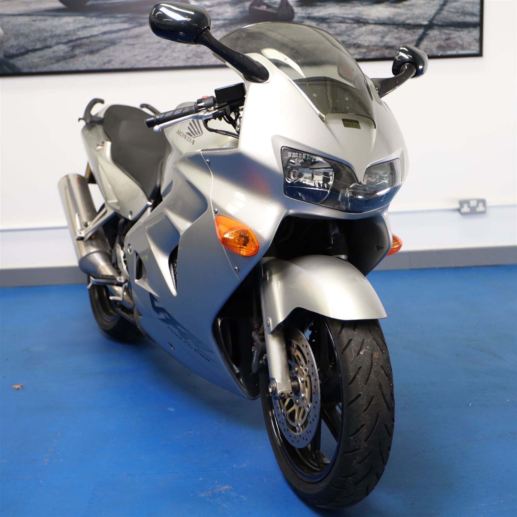 1998 Honda VFR800 FI Sports Touring Motorcycle

• Registration: R145 SUT
• Date of first registration: 1998
• Engine: 781cc V4 petrol
• Fuel system: Honda PGM-FI fuel injection
• Transmission: Manual
• Odometer reading: 11,700 miles
• Colour: Silver with black trim
• V5C: Present
• Keys: Two
• Security: Datatag immobiliser

A well-presented 1998 Honda VFR800 FI sports touring motorcycle, finished in silver with contrasting black trim and displaying a notably low odometer reading of 11,700 miles.

The VFR800 combines Honda’s renowned V4 engine with PGM-FI fuel injection and a combined braking system, creating a capable and refined motorcycle suited to both sporting and long-distance use.

Features include:

• Full factory fairing
• Tinted windscreen
• Honda PGM-FI fuel injection
• Combined braking system
• Twin front brake discs
• Factory exhaust system
• Alloy wheels
• Rear passenger grab handles
• Datatag immobiliser
• Digital instrument display

The motorcycle appears complete and largely original and has been stored indoors. It is presented in good overall condition, with light cosmetic marks consistent with its age and use.

This vehicle forms part of the Estate of the Late John Sils and is offered for sale by the Executors, confirming a genuine reason for sale.
