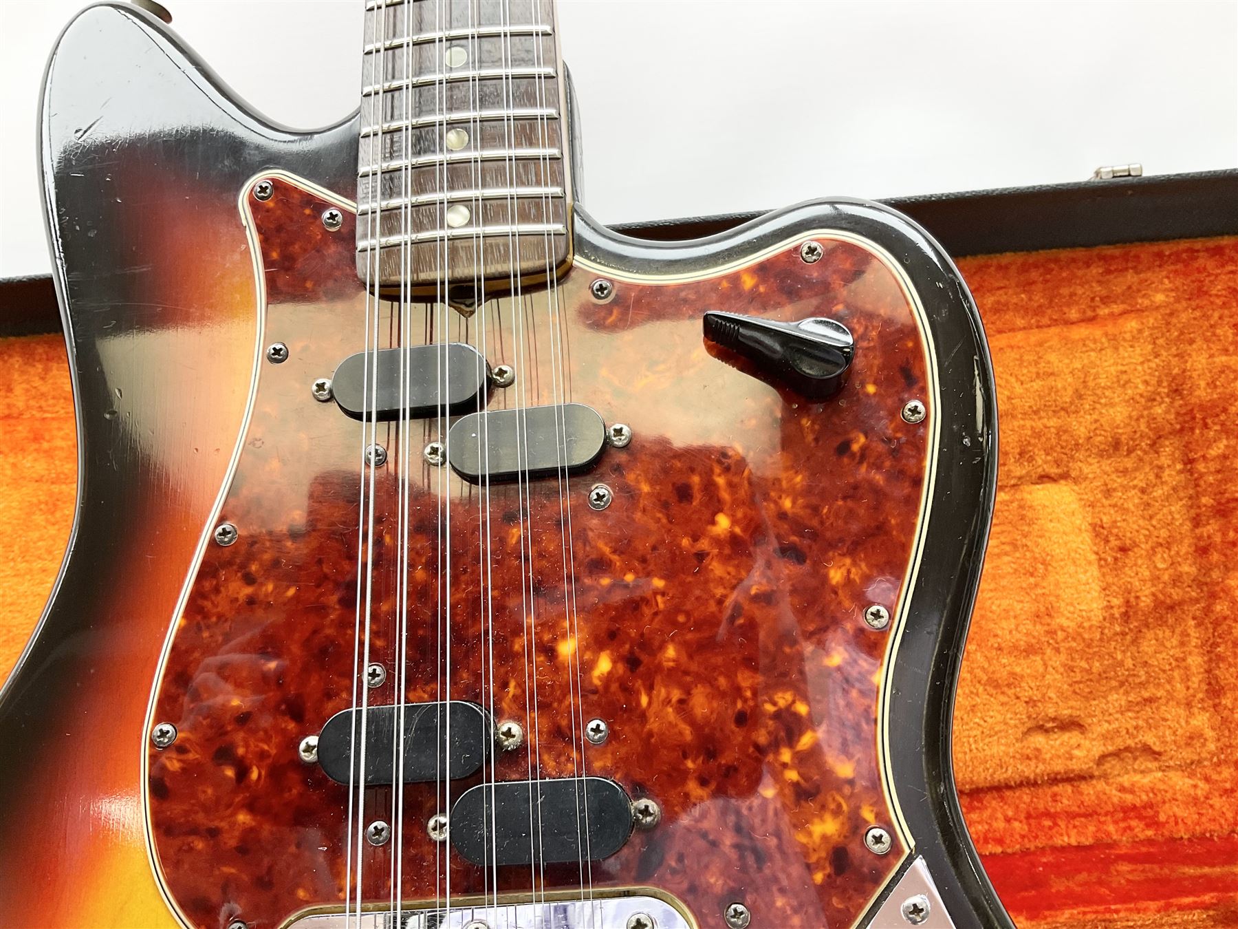 Fender three-tone Sunburst 12-string electric guitar c1965/6 Fullerton USA, with alder body and maple neck, the Indian rosewood fretboard with twenty-one frets and pearloid dot markers, fender electric XII bridge, F-stamp tuners (non-original), two split single coil pick-ups, master volume and tone and four-way switch, serial no.129730, L108cm; in original Fender case bearing label for Rivington Guitars New York with copy of original invoice; together with GuitarKes set-up and service certificate dated October 2021
