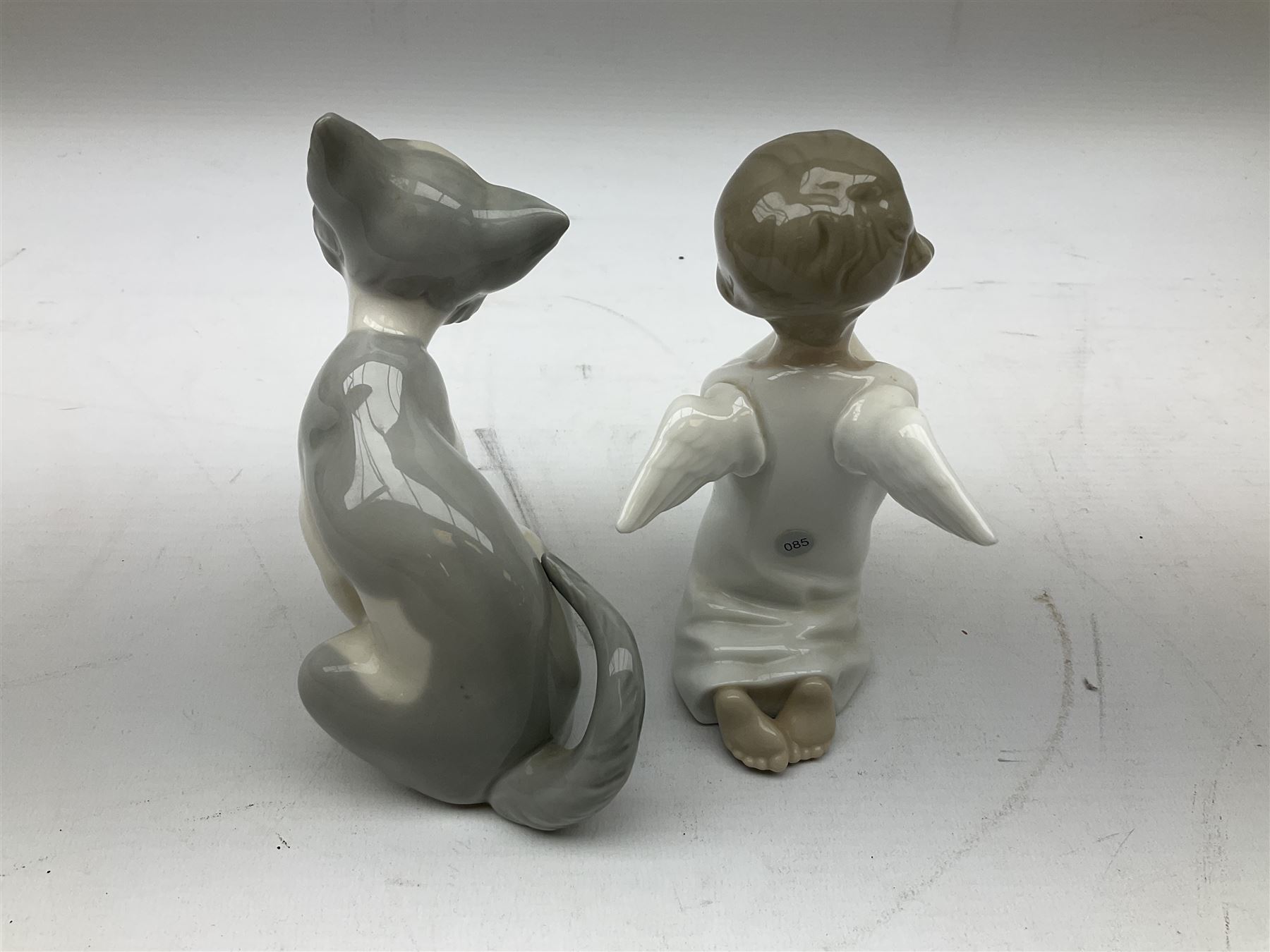 Lladro cat, modelled in a seated position, together with Lladro praying