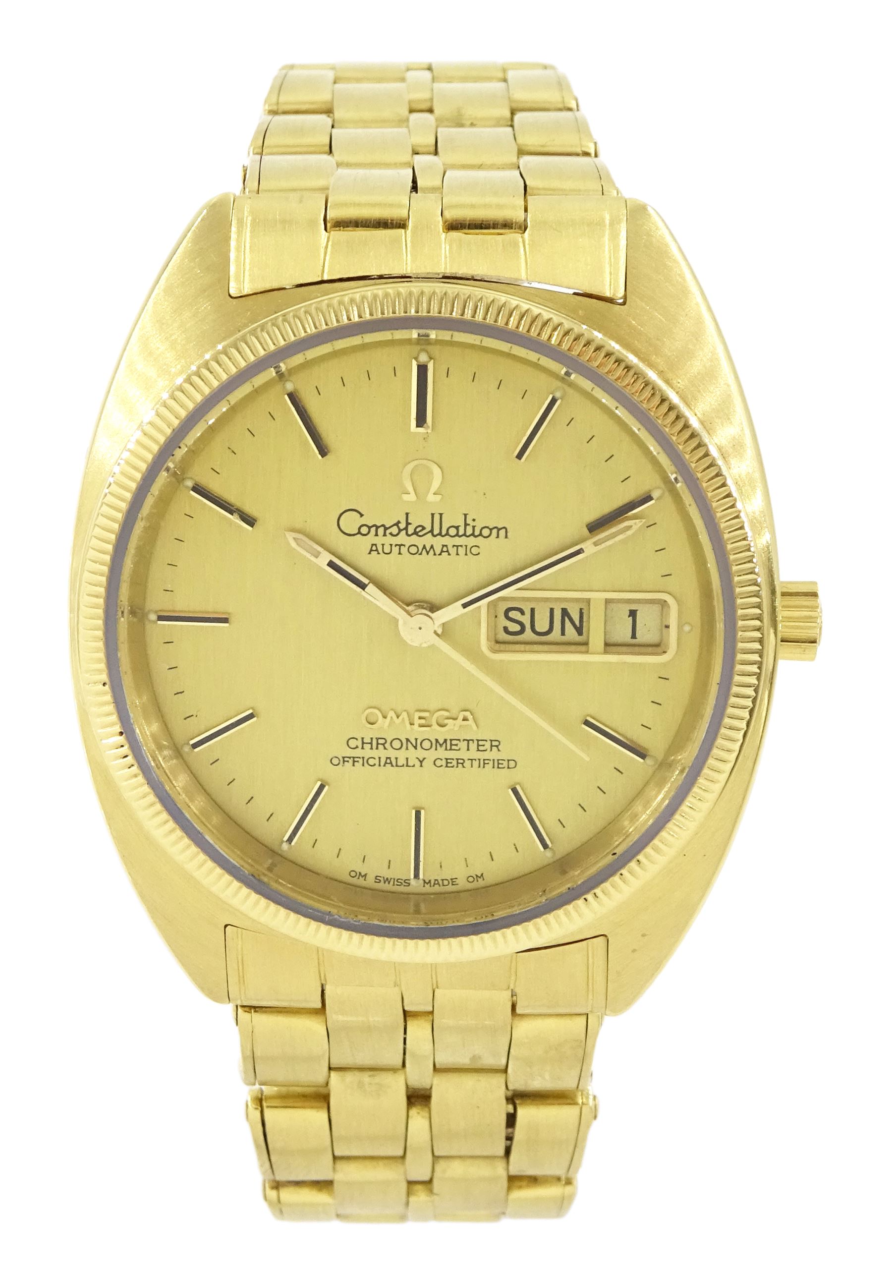 Omega Constellation gentleman's 18ct gold chronometer automatic wristwatch, Ref. 168.0057, Cal 1021, champagne dial with day / date aperture and baton hour markers, stamped 750 with Helvetia hallmark, on original 18ct gold expanding bracelet, with fold-over clasp, London import mark 1973