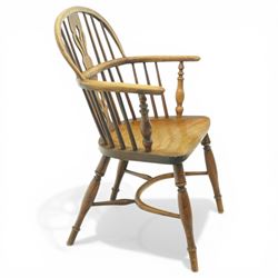 19th century low back elm Windsor armchair, hooped back with pierced central splat and radiating spindles, shaped arm bow over saddle seat, on turned supports united by crinoline stretcher