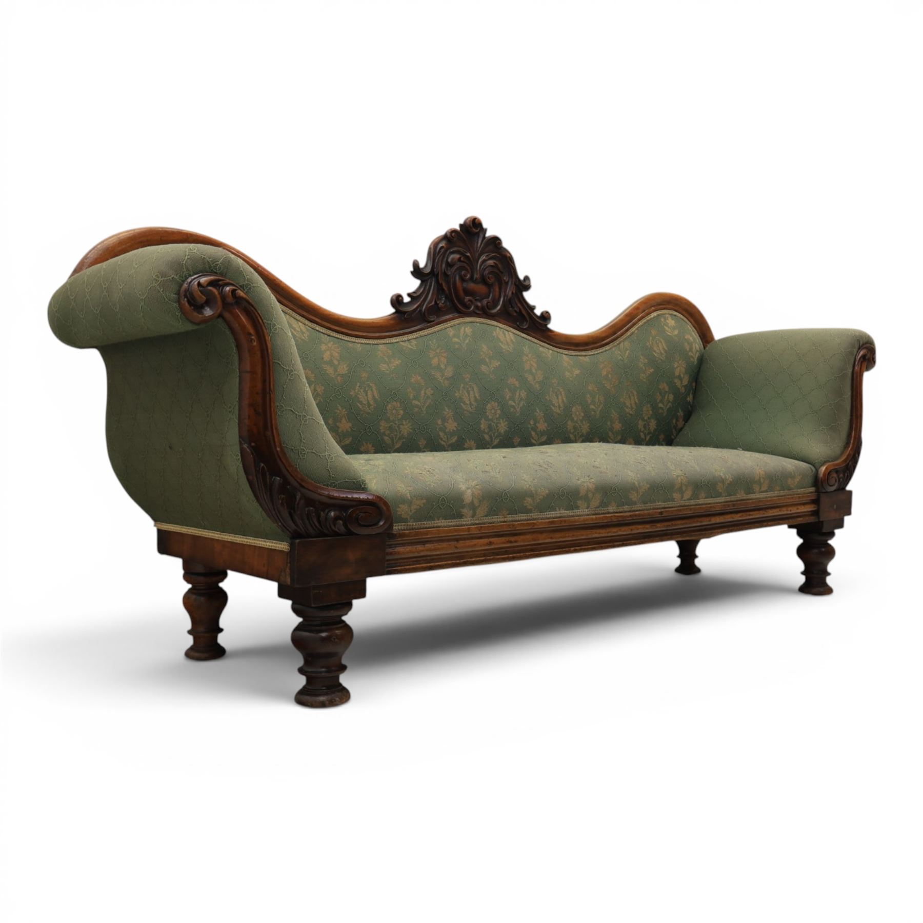 Victorian mahogany framed sofa, scroll arms with double camel back, green geometric upholstery, raised on turned supports