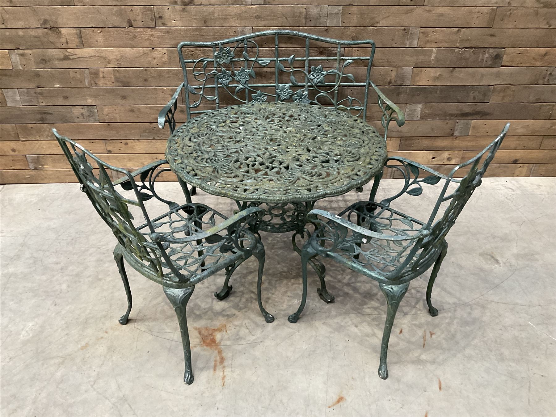 Cast aluminium garden dining set, comprising ornate circular table (D91cm, H68cm) a two seater bench, on cabriole supports (W118cm, H93cm, D55cm), and two matching armchairs (W55cm, H95cm, D54cm)