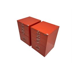 Two red finish 'Bisley' four drawer filing cabinet
