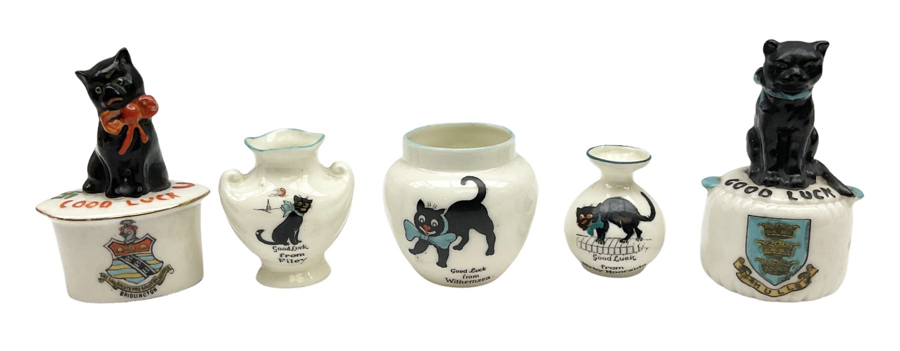 Five crested ware Good Luck black cats, comprising two Willow Art examples, two Arcadian examples and one Carlton China, to include Bridlington, Hull, Filey, etc, tallest H9cm
