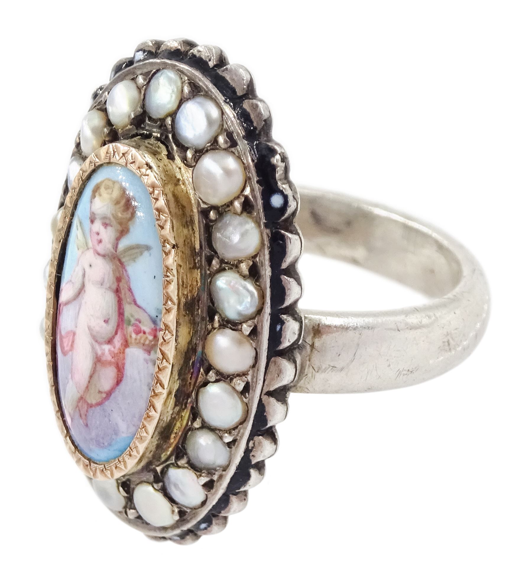 19th century French silver enamel portrait ring, set with an oval hand painted panel of a cherub, with split pearl surround
