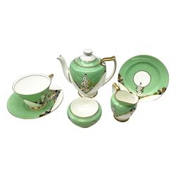 Royal Doulton Leonora pattern tea wares, Art Deco tea set the set with stylised gilded and painted flowers on a jade green and white background, comprising teapot, milk jug, open sucrier, tea cup,  saucer and dessert plate 