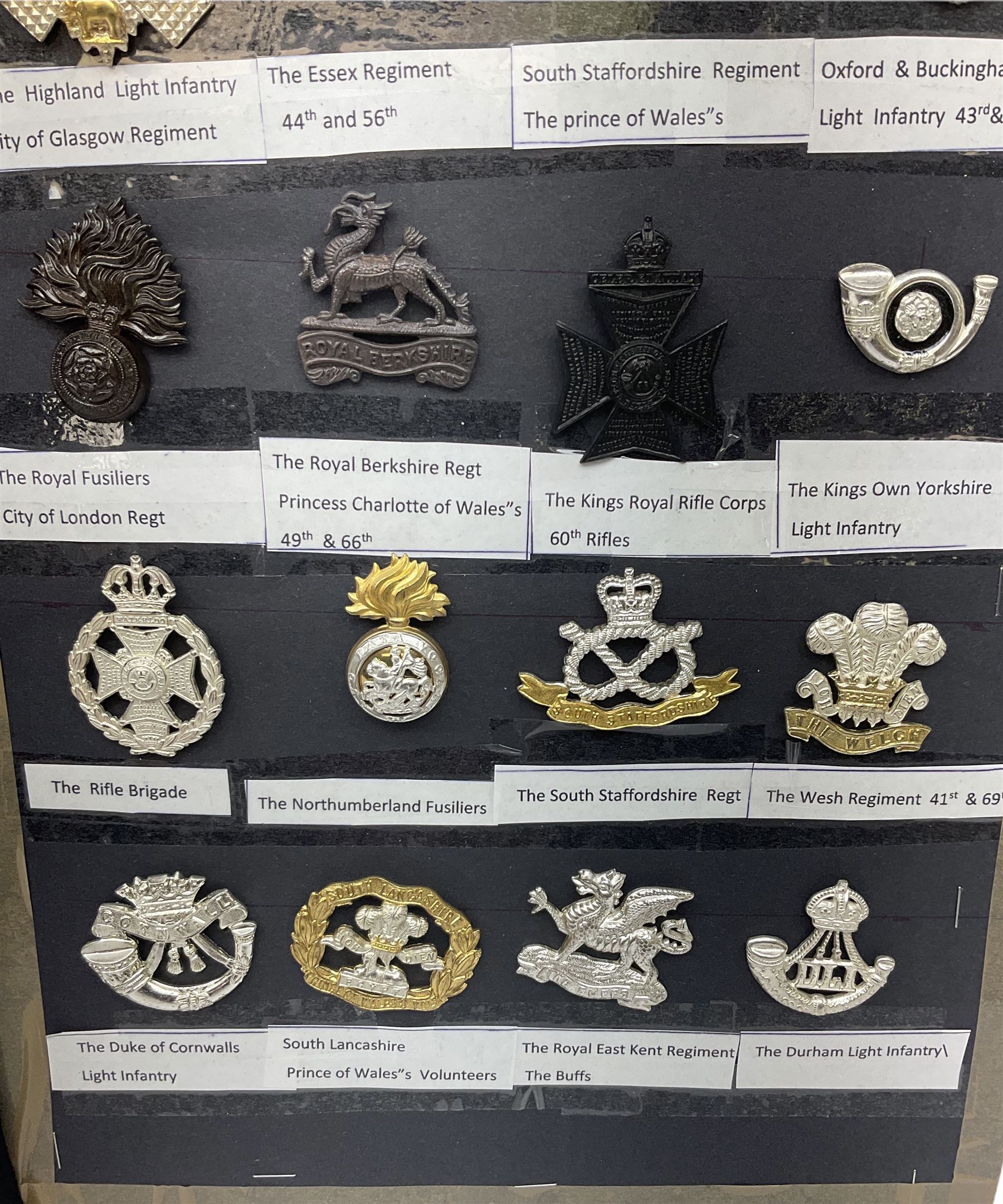 Collection of thirty-two reproduction military badges, including Royal Scots Fusiliers, Royal Lincolnshire Regiment, The Boarders Regiment etc. 