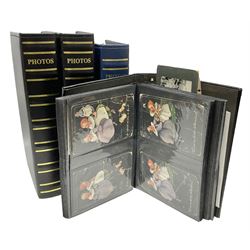 Four modern albums containing approximately eight-hundred and fifty Edwardian and later postcards including real photographic and printed topographical, novelty leather and wooden cards, applique etc