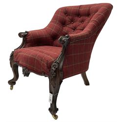 Victorian rosewood framed armchair, upholstered in buttoned tartan fabric, scrolled arm terminals graduating into cabriole supports with moulded flower head decoration and cartouche carved apron, over scroll feet with brass castors