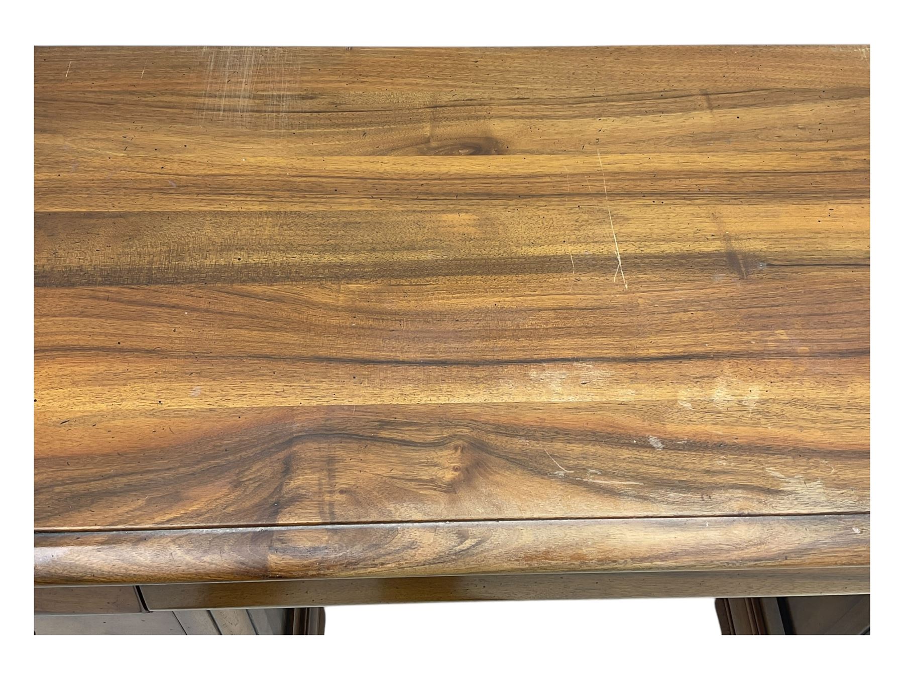 French cherry wood kneehole desk or dressing table, moulded rectangular top over twin pedestal bases each housing three drawers with brass-effect swing handles, resting on bracket feet