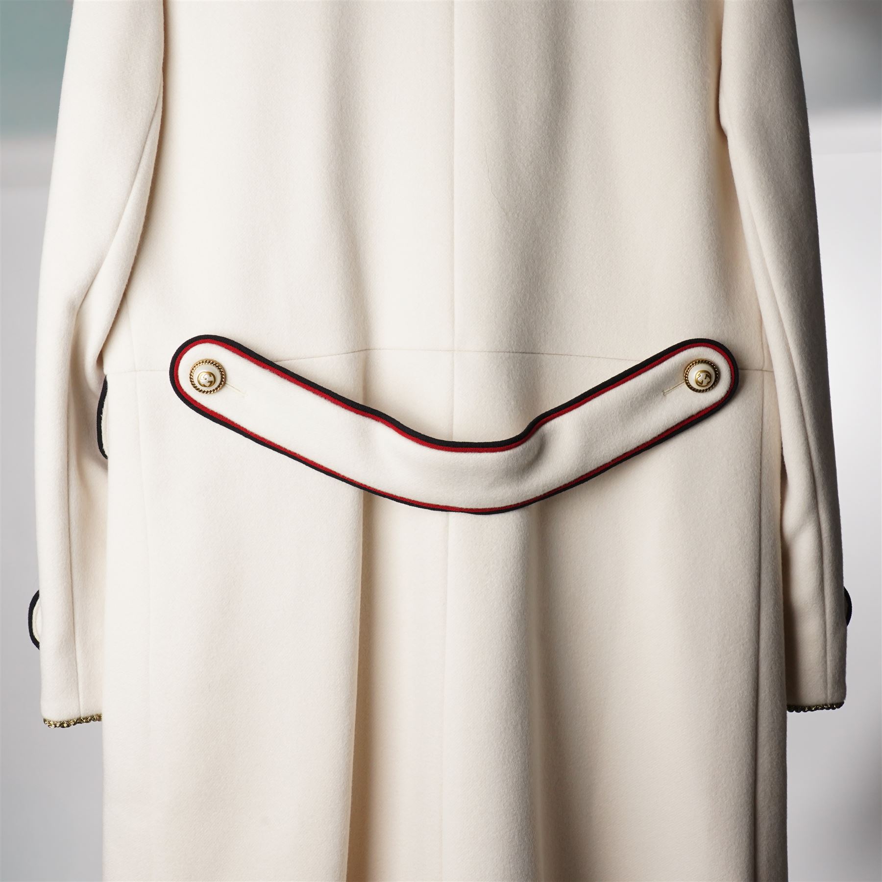 Gucci - bee embroidered wool single-breasted military coat, from the Autumn/Winter 2017 collection under Alessandro Michele, in ivory, with stand collar, red and navy trim, pearlescent and gold-tone button fastening and embroidered bee detailing to the collar, size 14, unused with original garment bag and tags