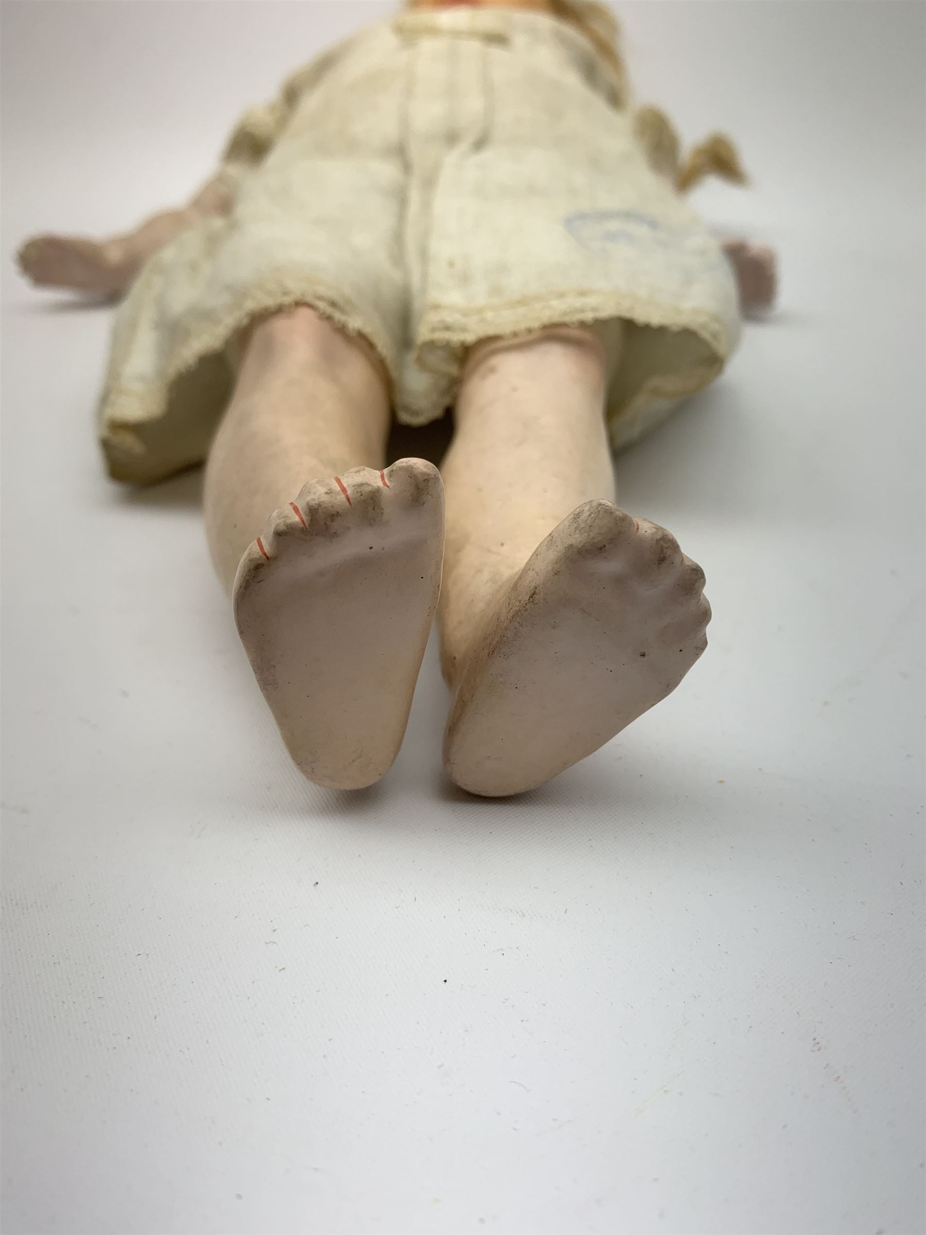 Early 20th century Cuno and Otto Dressel wax shoulder head doll with applied hair and fixed glass eyes, soft body with jointed composition lower limbs, maker's stamp to right thigh, clothing and box H38cm in original box