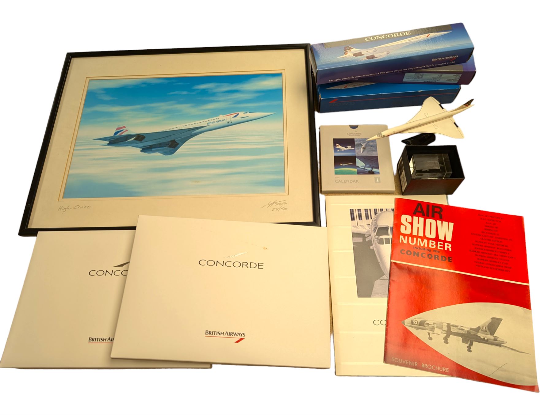 Collection of Concorde memorabilia, including paperweight, limited edition print, calendars, scale model, etc 