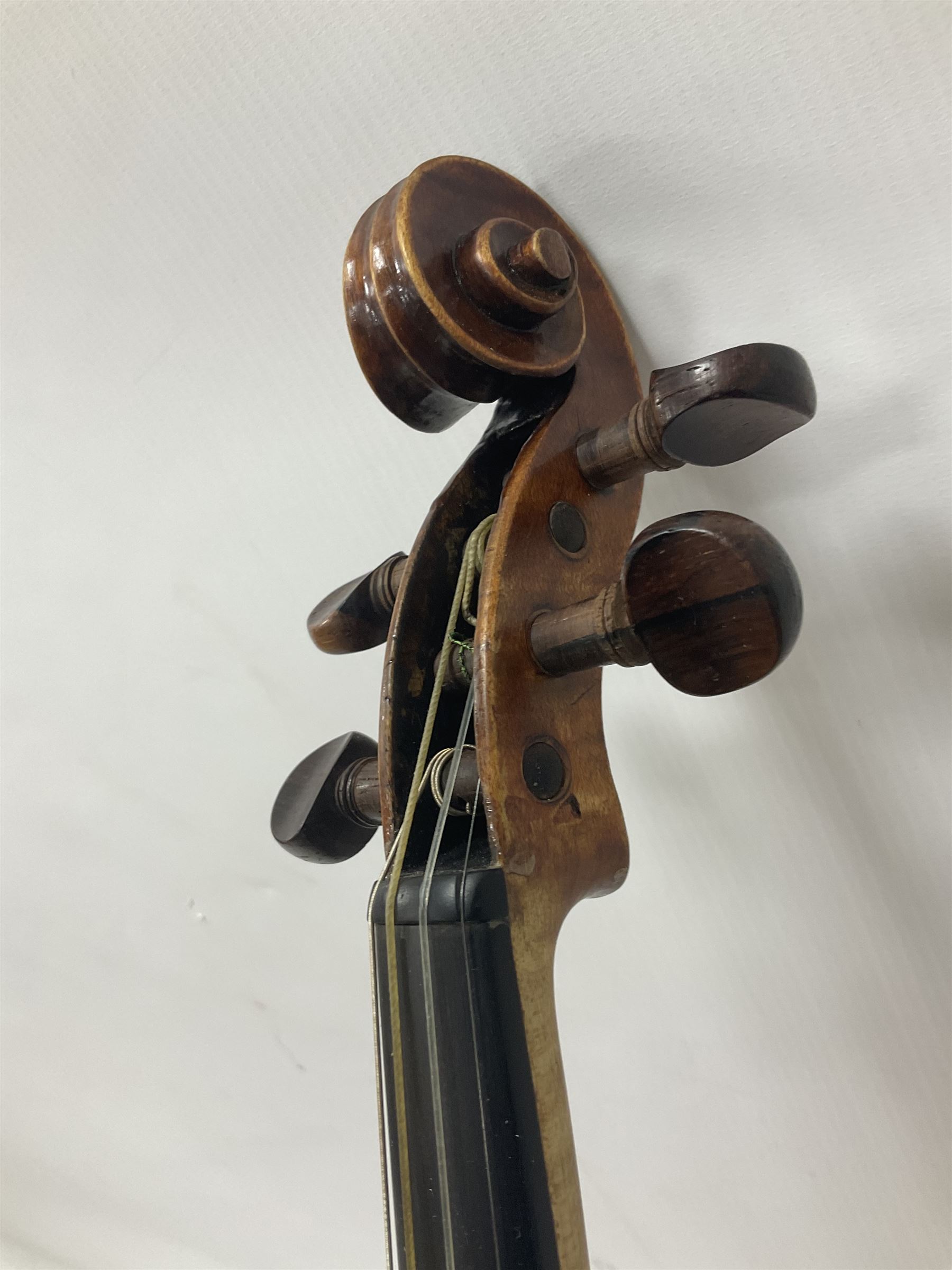 19th century full sized violin in a later hard case, decorative mother of pearl inlay to the tail piece Overall length 60cm No bow