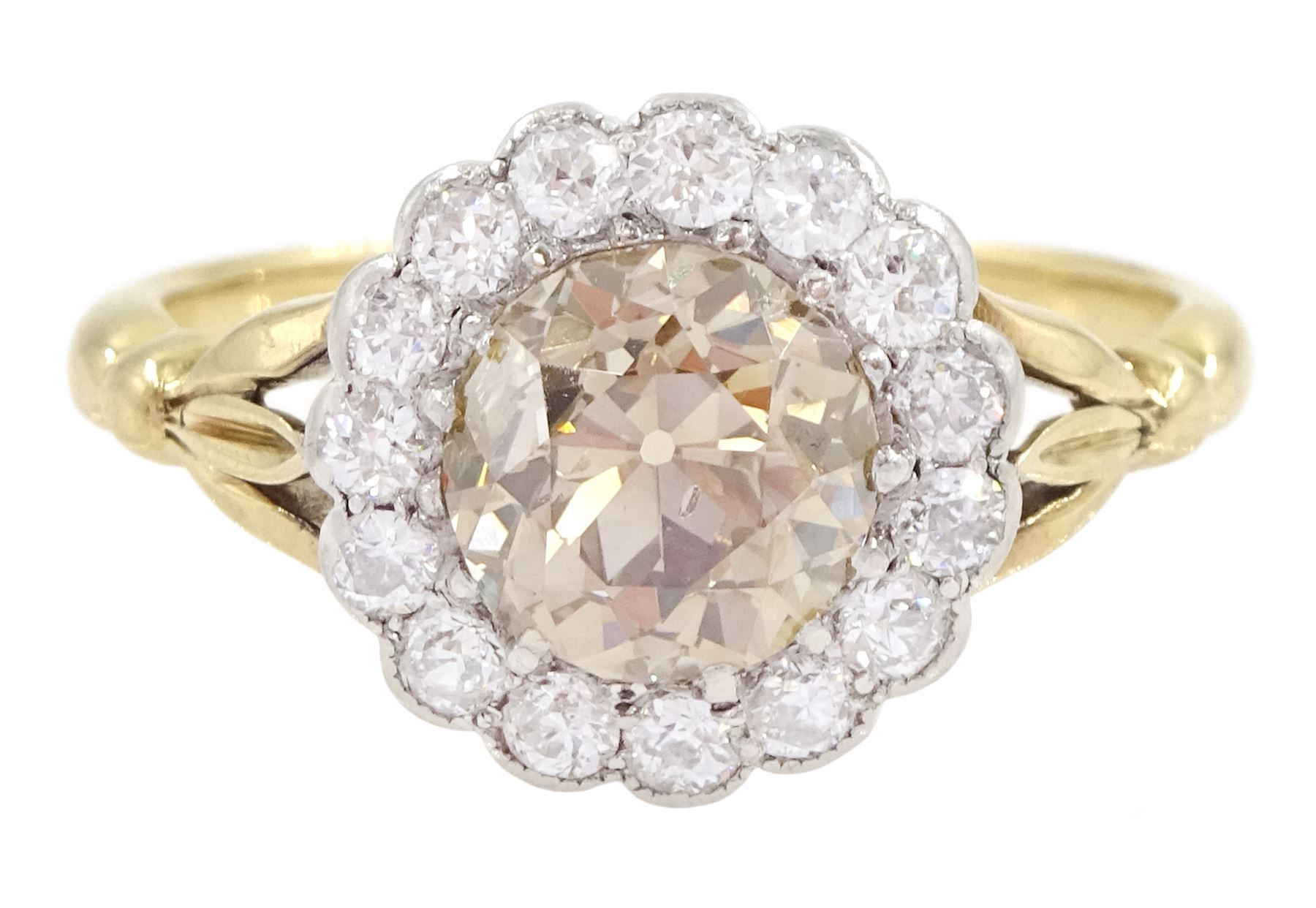 Early 20th century 18ct gold old cut diamond cluster ring, the central fancy light brown diamond of approx 1.60 carat, with a milgrain set white diamond surround of approx 0.45 carat, with Guest & Philips insurance valuation