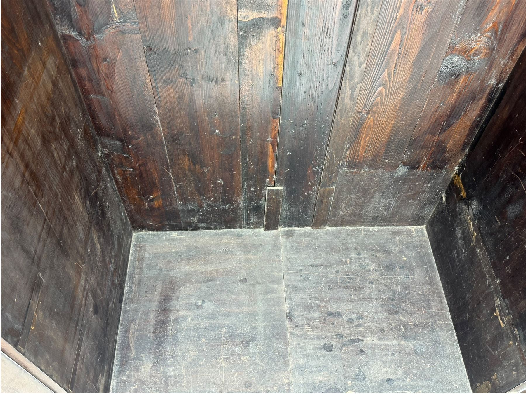 Victorian figured walnut single wardrobe, the moulded cornice with a central diamond motif over a pair of arched panelled doors with striking book-matched veneers, enclosing a fitted interior with hanging rail and hooks, on a plinth base