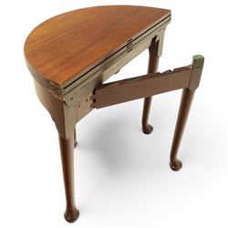 20th-century Georgian Revival style double fold-over card table, the first hinged circular top with polished mahogany surface above a second hinged circular top revealing a green baize playing surface with four counter-wells, underneath with a recessed compartment with and  chip and dice wells, the apron with fitted lock and key, raised on slender straight legs with pad feet 
