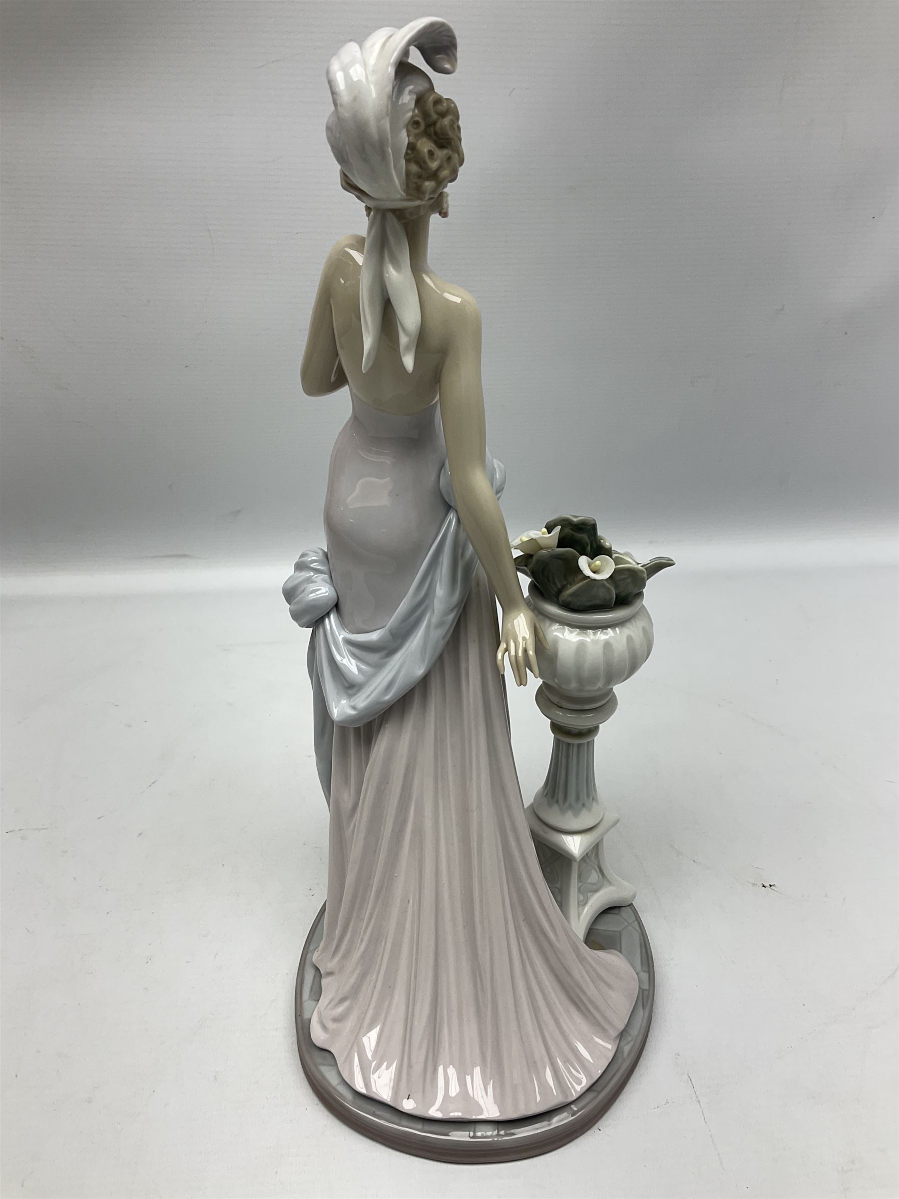 Four Lladro figures, comprising Touch of Class no 5377, Boy Student no 4517, Ocean Beauty no 5785 and Carnival Couple no 4882, largest example H45cm