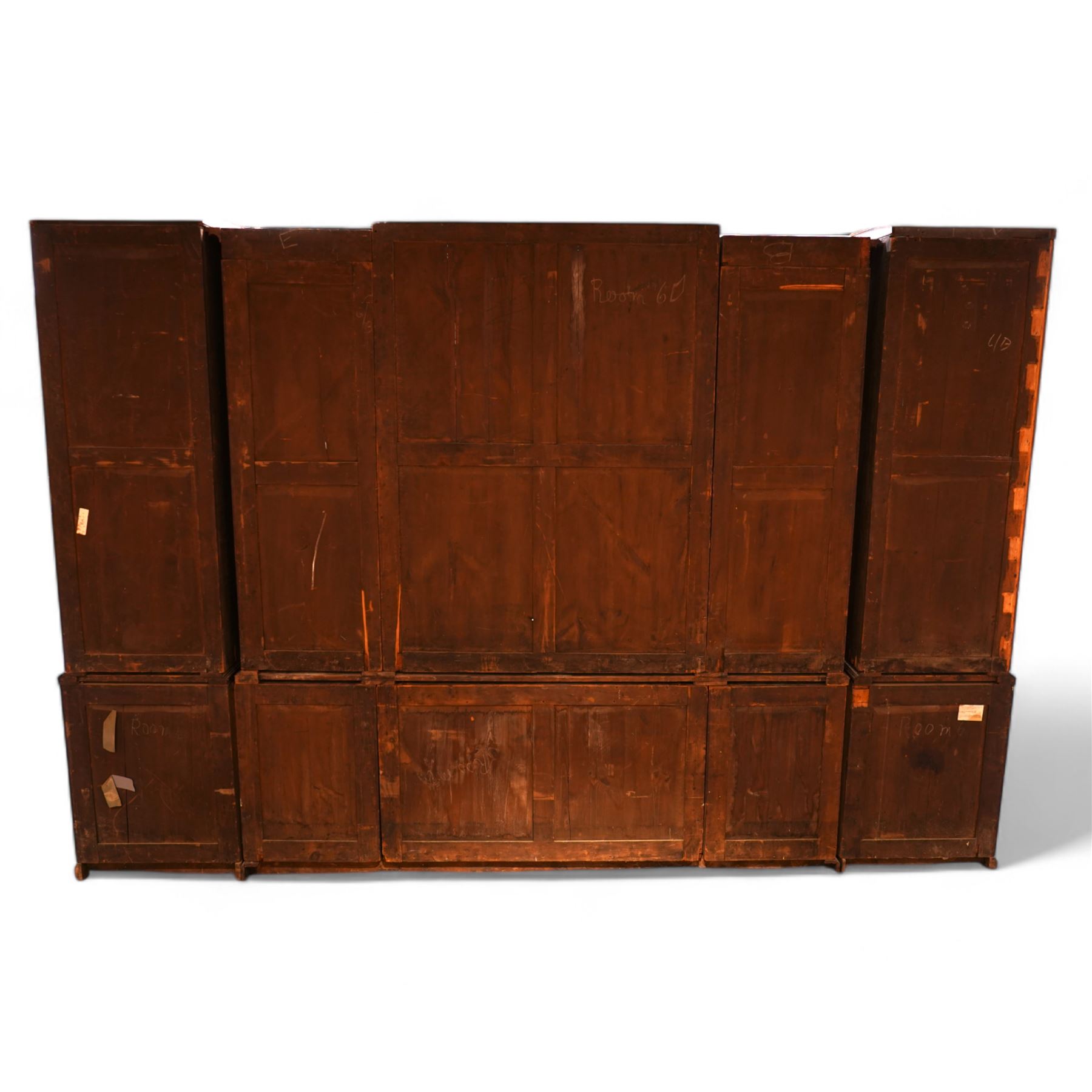 Large Georgian mahogany library bookcase, projecting moulded cornice with row of globular mounts, adjustable shelving enclosed by six astragal glazed doors, fitted with two slides and six panelled cupboard doors, two banks of five drawers, on moulded plinth base; together with two pairs of associated astragal glazed doors in mahogany, from the same property (W55.5cm x H168cm & W48cm x 168cm)