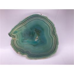 Pair of green agate slices, polished with rough edges, raised upon silvered metal stands, H23cm