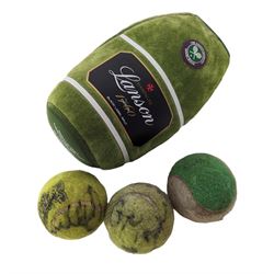 Three tennis balls, two with indistinct 