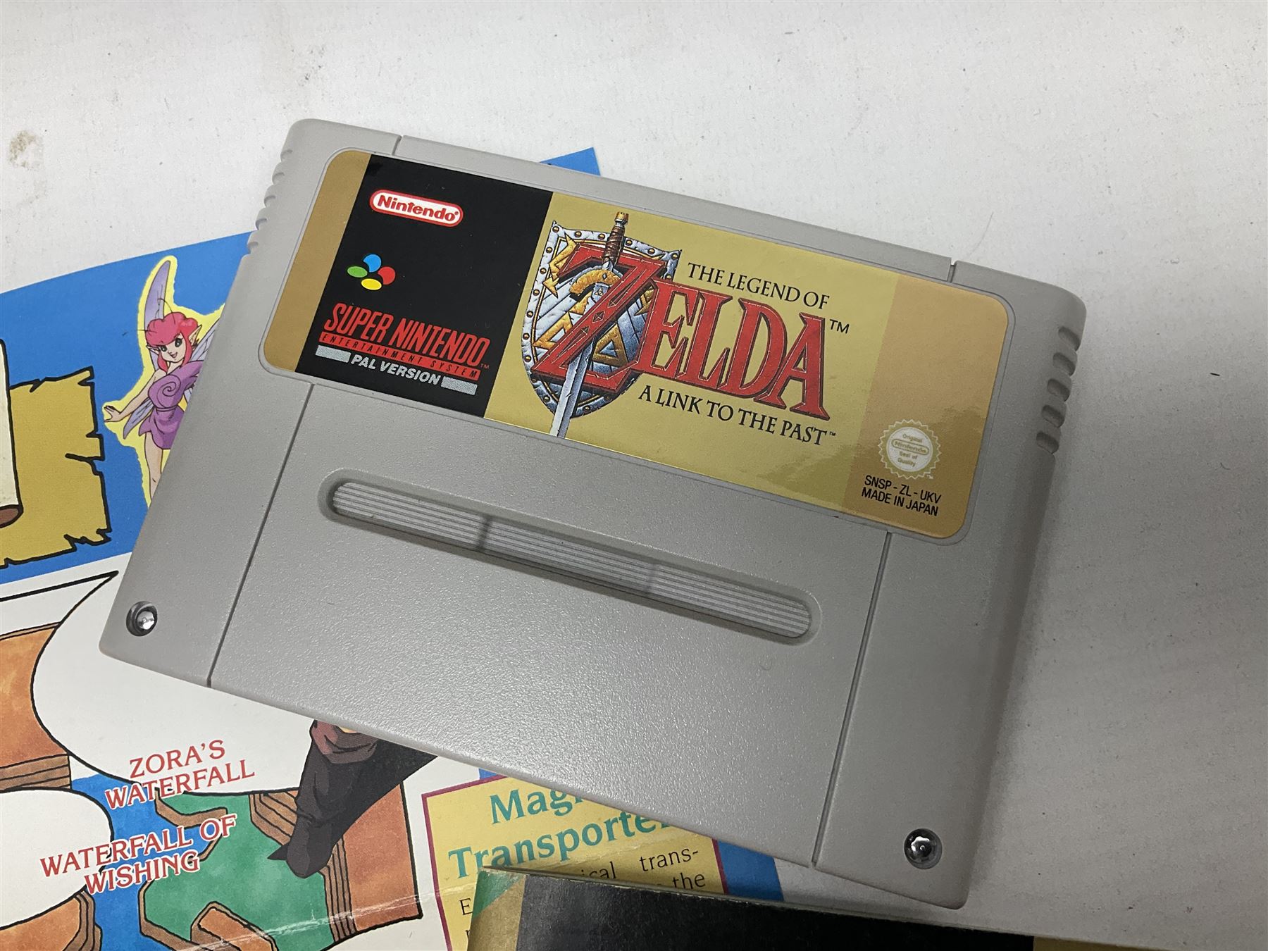 Two Super Nintendo Entertainment System (PAL) controllers, accessories and games. Super NES Game Commander with original box and instruction booklet, Super NES Nintendo Scope (1992) transmitter gun, receiver, Super NES Nintendo Scope 6 game with original instruction booklets. Further games to include ‘The Legend of Zelda a Link to the Past’, ‘Super Mario World’, ‘Super Mario Kart’, ‘The Lawnmower Man’, and ‘Exhaust Heat’, all with original instruction booklets. ‘PowerMonger’ and Disney’s ‘Aladdin’ game cartridges only 