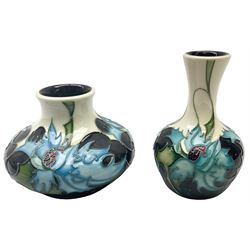 Two Moorcroft vases, decorated in the Thistles pattern designed by Eric Kals, with impressed and painted marks beneath, tallest example H11.5cm. 
