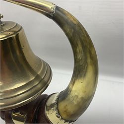 Early 20th century oak and horn dinner bell, the silvered bell suspended from a pair of cow horns, with silver plated mounts and blank shield shaped cartouche, upon square base, H37cm